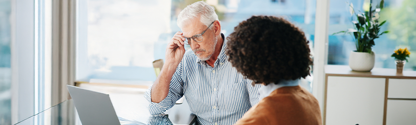 two people discussing tax documents